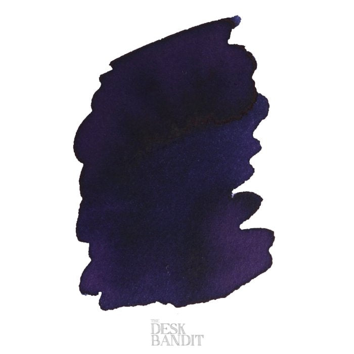 Swatch of Robert Oster's Purple Jazz ink, showcasing its deep blue-purple hue on paper, with The Desk Bandit watermark visible at the bottom.