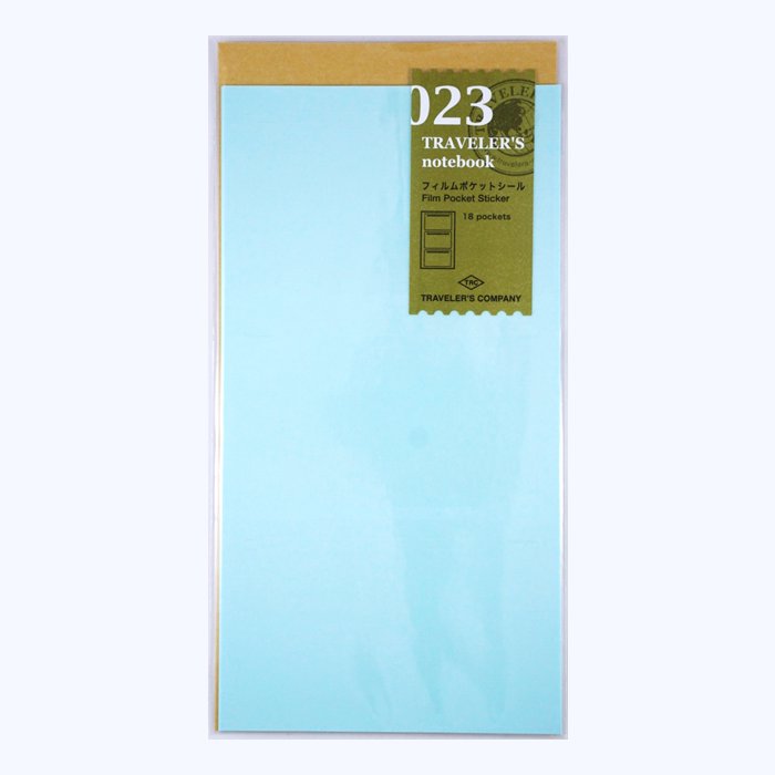 Package of #023 Film Pocket Sticker (18 slots) for Traveler's Notebook by TRAVELER'S COMPANY, featuring peelable pale blue sheets for creating clear pockets in notebooks.