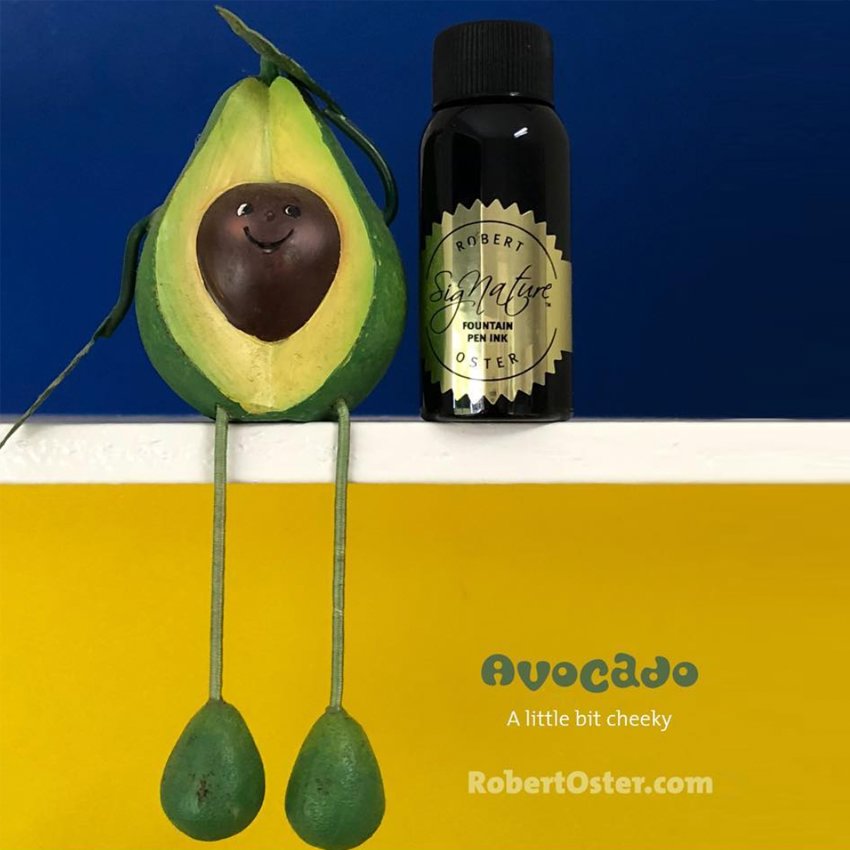Robert Oster Signature Ink, Avocado - 50ml, next to a smiling half-avocado character, highlighting the playful branding and unique Australian-inspired shade.