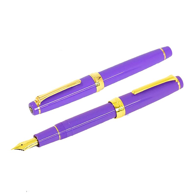 Two Nagasawa Original Professional Gear - Rokko Shichidank pens, one capped, one uncapped, revealing a gold nib, with gold-colored trim.