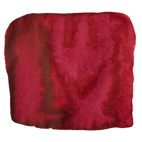 Abstract swatch of deep red pigment representing LAMY T53 Crystal Ink - Ruby - 2ml, showcasing its vibrant dye-based hue, ideal for high-quality writing.