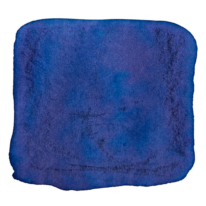 Ink Studio #243 - 20ml bottle, shown with a soft, blue microfiber cleaning cloth, highlighting its fuzzy texture against the ink product's compact design.