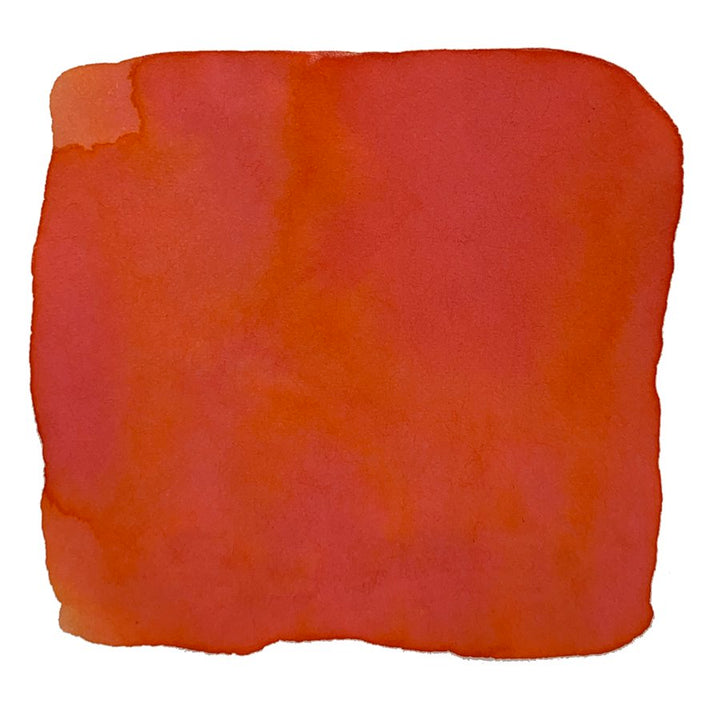 Ink Studio #473 - 20ml: A swatch of red watercolor paint with soft, uneven edges on a white background, showcasing varying red and orange tones.