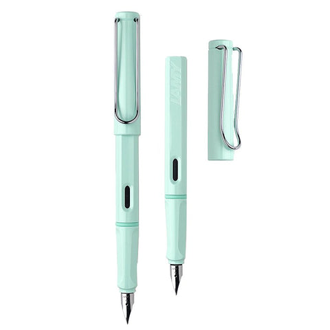 Two mint-green LAMY Safari Pastels (Blue Macaron) fountain pens, one capped, one uncapped, showing fine stainless steel nibs and distinctive wire clips.