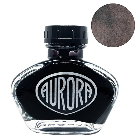Aurora 100th Anniversary - Sepia (55ml) ink bottle with teardrop-shaped design and AURORA logo, displayed next to a circular swatch of its dark brown color.