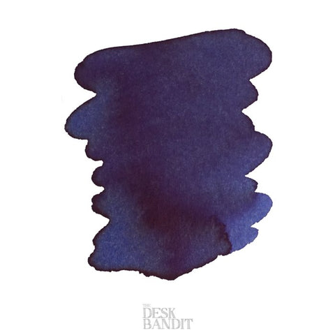 Iroshizuku Ink - Shin-Kai (2ml) sample, showing a blotchy, organic deep navy-to-purplish blue swatch on a white background with The Desk Bandit watermark.