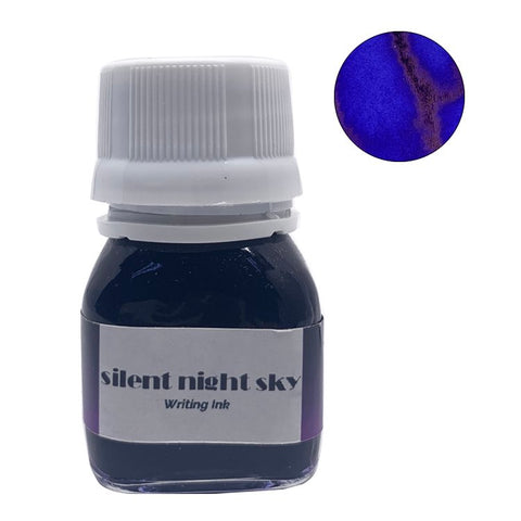 Silent Night Sky - 20ml bottle of deep blue Krishna ink, showing an ultramarine core with purplish outline and coppery sheen swatch. Handcrafted in Kerala.