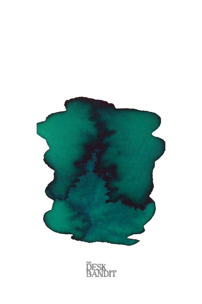 Smaragdgrun (2ml) ink sample by Rohrer & Klingner, featuring a blue-green/teal abstract swatch with THE DESK BANDIT text beneath, showcasing its vibrant hue.