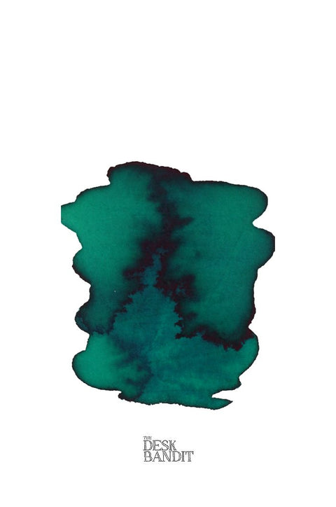 Smaragdgrun (2ml) ink sample by Rohrer & Klingner, featuring a blue-green/teal abstract swatch with THE DESK BANDIT text beneath, showcasing its vibrant hue.