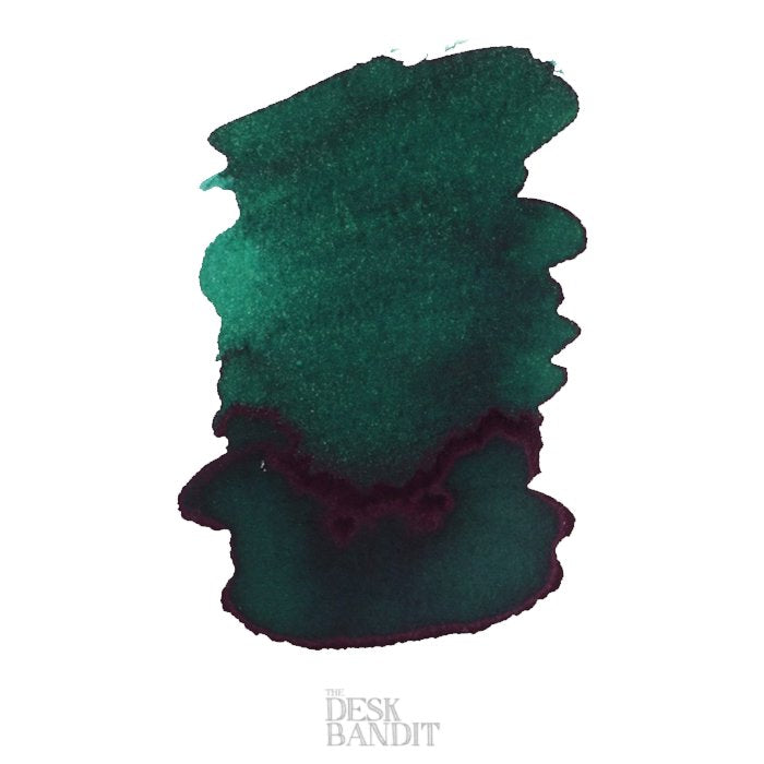 Spearmint - 50ml: Deep teal-green ink swatch with purplish sheen edges on white stock, featuring THE DESK BANDIT watermark, representing Robert Oster&