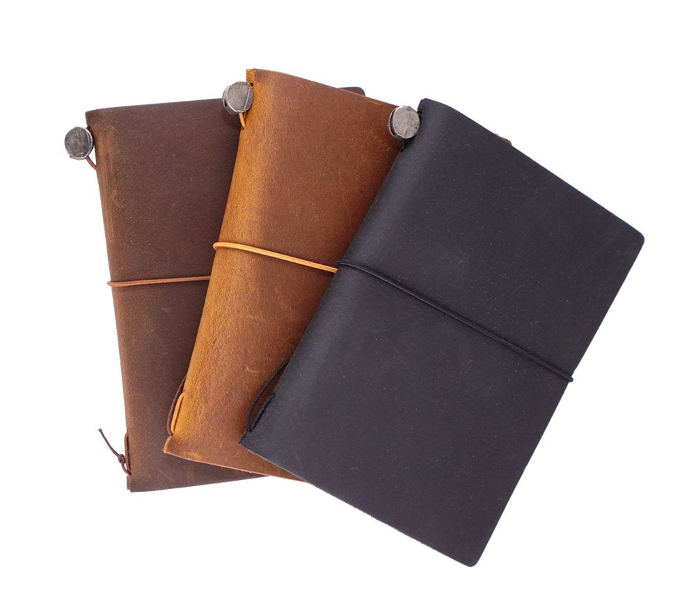 Three Passport Leather Cover (Camel) notebooks with elastic bands, showcasing their handmade leather design, each accompanied by a blank notebook, spare elastic, and cotton pouch.
