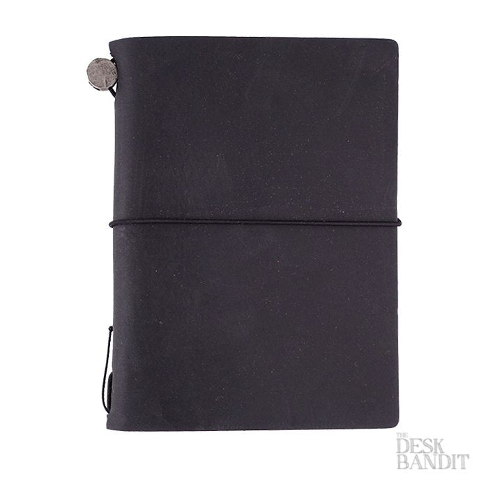 Passport Leather Cover (Black) with elastic closure and metal charm, hand-made in Chiangmai, featuring refillable design, includes a blank notebook and cotton pouch.
