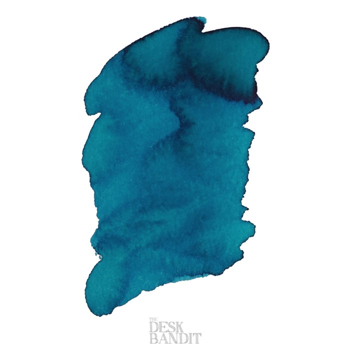 Abstract blue ink swatch on white paper, showcasing varying saturation for Robert Oster's Torquay - 2ml sample from The Desk Bandit, highlighting dye-based qualities.