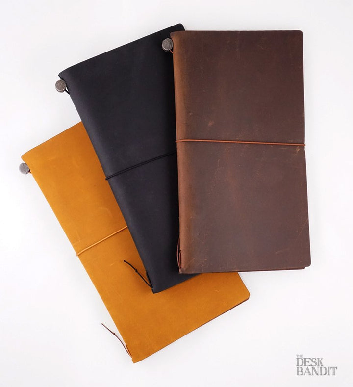Leather Cover (Black) notebook with elastic closure, part of a handmade Chiangmai set, includes a blank notebook, spare band, and cotton pouch, branded The Desk Bandit.