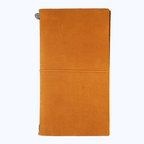Leather Cover (Camel) features a tan-brown leather, traveler-style notebook with an elastic closure, showcasing simplicity and rustic charm. Includes a blank notebook and cotton pouch.