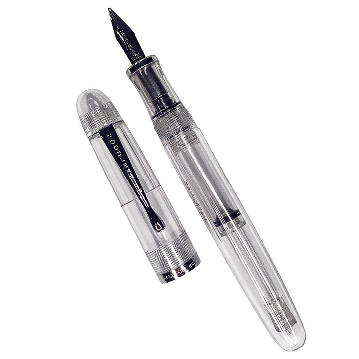 Triple Tail Flex Pen by Noodler's Ink, featuring a transparent body with visible ink reservoir and a three-tine flex nib, cap placed beside the barrel.