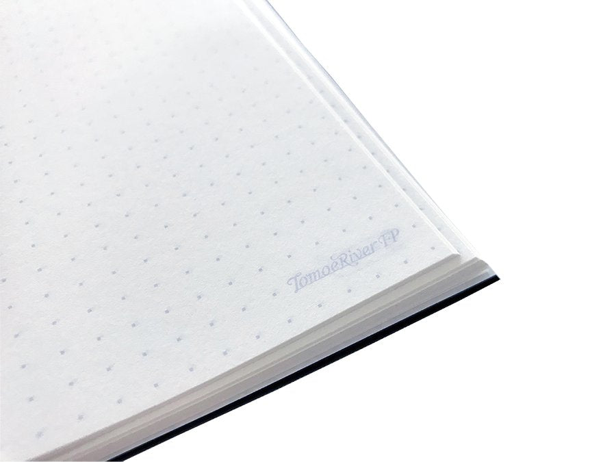 Close-up of the Tomoe River Notebook A5 - Dot Grid corner, showcasing dot-grid pattern and TomoeRiverFP branding, ideal for bullet journaling or sketching.