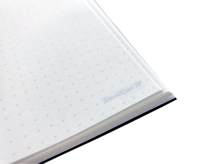 Close-up of the Tomoe River Notebook A5 - Dot Grid corner, showcasing dot-grid pattern and TomoeRiverFP branding, ideal for bullet journaling or sketching.