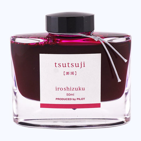 Iroshizuku Ink - Tsutsuji (50ml) in a glass bottle with a black cap, silver cord, and label detailing, showcasing Pilot's azalea-inspired deep pink ink.