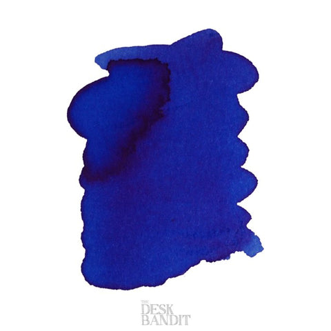 Iroshizuku Ink - Tsuyu-Kusa (2ml) sample, deep blue ink swatch on white background with faint The Desk Bandit logo, showcasing Pilot's Asiatic Dayflower shade.