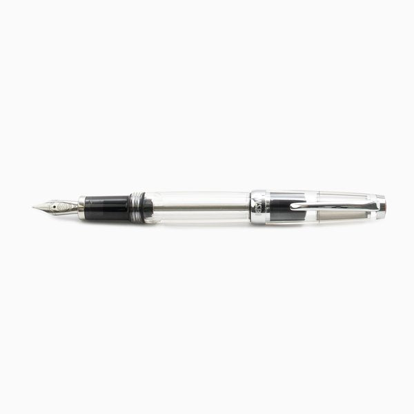 VAC Mini (Smoke) - Broad fountain pen with a clear barrel, visible ink reservoir, metal nib, and screw-on cap with pocket clip, ideal for travel.