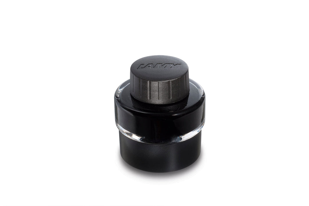 Lamy 2000 - Broad fountain pen ink bottle, featuring a cylindrical glass jar with black ink and a black cap embossed with the Lamy logo.